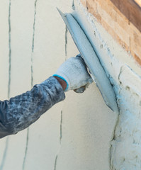 Worker Smoothing Wet Pool Plaster With Trowel