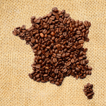 Whole bean coffee. The contour of the France is made of coffee beans on jute burlap