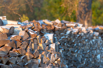 Woodpile. Firewood stacked in a woodpile. Large stock of firewood.