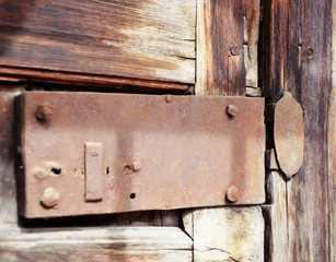 wrought iron lock on wooden window