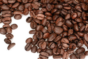 Roasted coffee beans, dark brown close up isolated on a white background