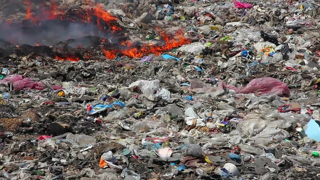Burning garbage dump pollution, landfill near the city