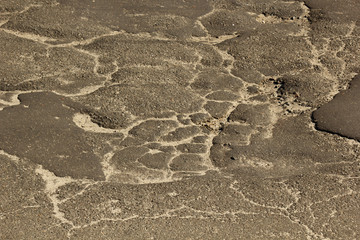 cracked blue asphalt ground closeup. damaged structure background