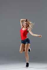Fototapeta na wymiar Hip hop dancer moving and jumping in photostudio