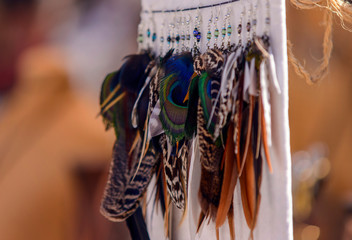 Fototapeta na wymiar Colorful Feather Earring on the market sale