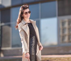 Obraz premium successful young woman standing on the street near the office building