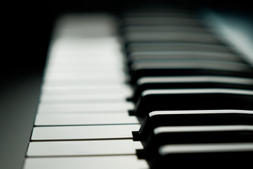 Black background with piano keys close up