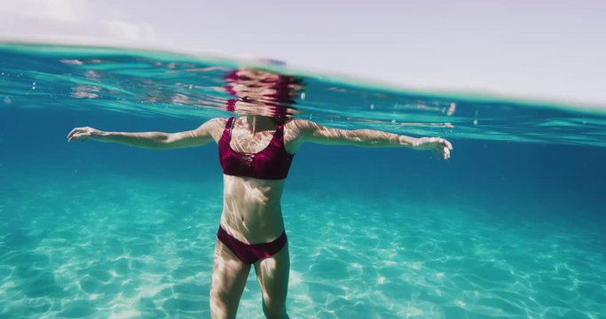 Beautiful woman swimming in underwater paradise