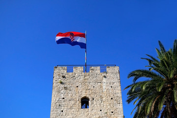 Historic town gate of town Korcula, on island Korcula, Croatia. Flag of Croatia on the top. 