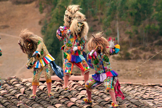 Paucartambo, Cusco, Peru - Circa July 2013: Typical devil rooftop dancers called 'Saqras' at Paucartambo religious festival of Virgen del Carmen. Group of dancers with traditional folkloric clothes.