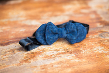 Blue bow-tie on a wooden table
