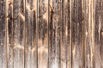 Fototapeta premium old vertical weathered boards, texture of dark antique wood panels, decor abstraction background