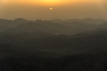 View of the sunrise on the bare mountain from the top of the mountain