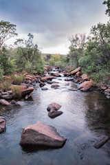 Stream with dark cloudy sky