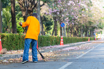 Asian man worker cleaning the road