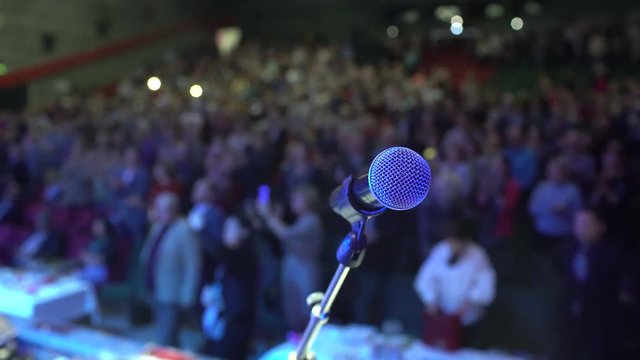 seminar audience from stage, conference, Microphone on background of applause auditorium. Close-Up group of business many people applauding, meeting training coach speaker group successful speech 4 K