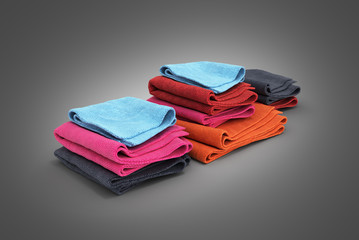Pile of colored towels isolated on black gradient background 3d