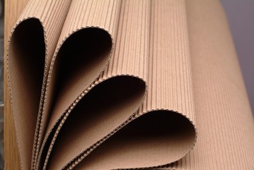 Close up of a roll of cardboard creates a wavy background.