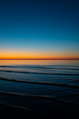 Vivid amazing sunset in Baltic States - Dusk in the sea with horizon illuminates by the sun