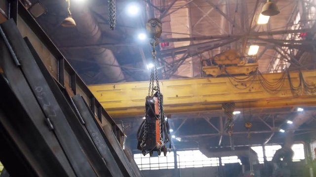 Industrial concept. A crane lifting a big detail