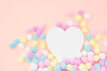 Fototapeta na wymiar Heart and Pastel colored fluffy decoration Balls