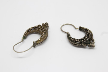 a pair of antique silver earrings closeup