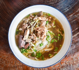 delicious noodles bowl / close up of vermicelli noodles soup with pork stew blood cubes and vegetable