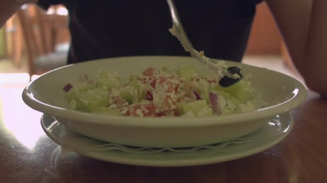 Time lapse woman eating caesar salad. Close-up on a plate.