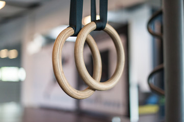 Wooden turn rings in fitness hall