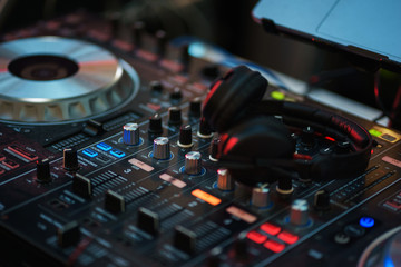Fototapeta na wymiar DJ equipment. Player and mixing console with headphones. 