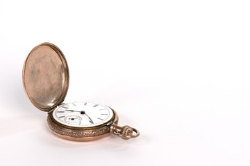 Antique gold pocket watch isolated on white with copy space