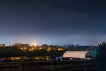 Obraz premium Warehouse equipment and building materials at night. Arched construction. White dome room.