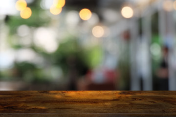 Empty dark wooden table in front of abstract blurred bokeh background of restaurant . can be used for display or montage your products.Mock up for space.