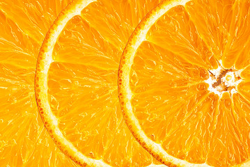 Background of half cut oranges on orange background