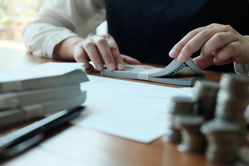 Businessman analyzing investment charts and pressing calculator buttons over documents. Accounting Concept  Saving Economy concept.