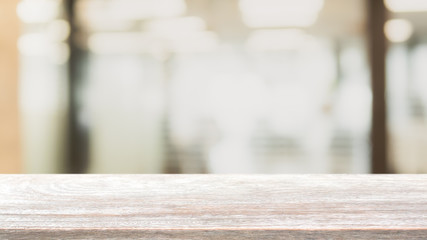 Empty wood table top and blurred bokeh restaurant interior background - can used for display or montage your products.