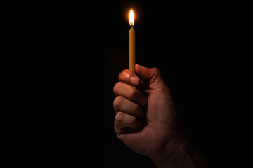 hand holding burning candle 