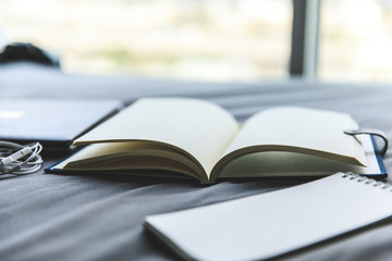 close up book open on bed in the morning 