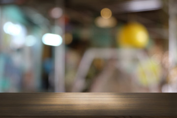 Empty dark wooden table in front of abstract blurred bokeh background of restaurant . can be used for display or montage your products.Mock up for space.