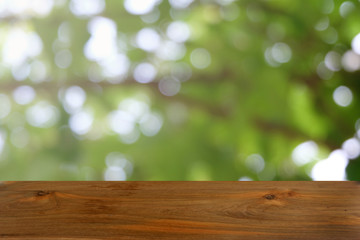 Empty dark wooden table in front of abstract blurred bokeh background of restaurant . can be used for display or montage your products.Mock up for space.