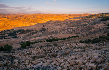 Dramatic orange sunset in mountains in Jordan