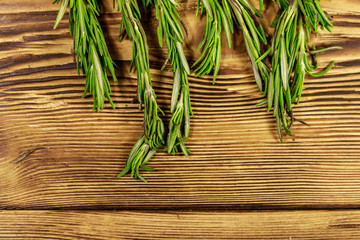 Fresh rosemary herbs on a wooden table. Top view