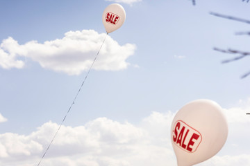 Balloons outdoors to advertise shop sales with discounts background