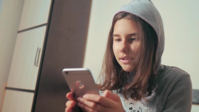 online shopping online retail service based . little teen girl writes a message chatting in social media messenger. children technology and communication concept. teenage girl with smartphone. girl