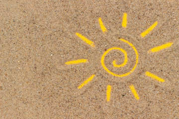 Sun sign drawn on sand. Creative top view Copy space