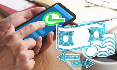 Using smartphone for online payment and money transfer.Closeup of male hands touching smartphone screen for using app at table.