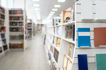 Blank bestsellers on shelf in book shop store with blurred back plane