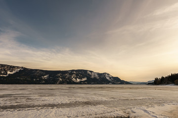 Sunset landscape of frozen Little Shuswap Lake British Columbia Canada.