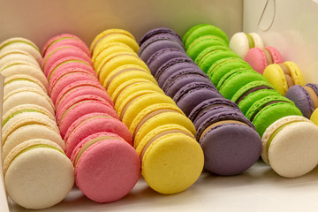 Many beautiful colored macarons in the box