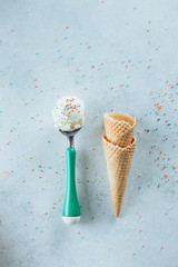 Ice cream spoon with waffle cones. Summer Dessert ice-cream, yummy delicious treat. Top view, copy space. Blue background